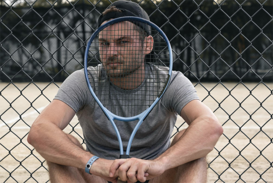 Tennis player pausing between points to refocus during competition.
